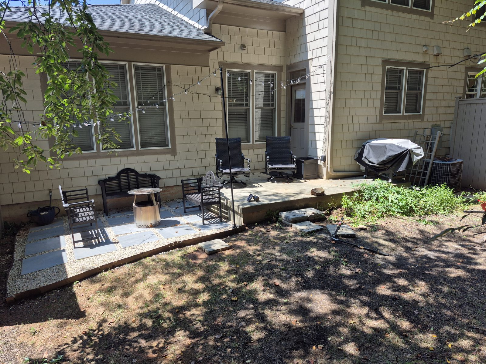 Bare concrete patio before the shade garden project began