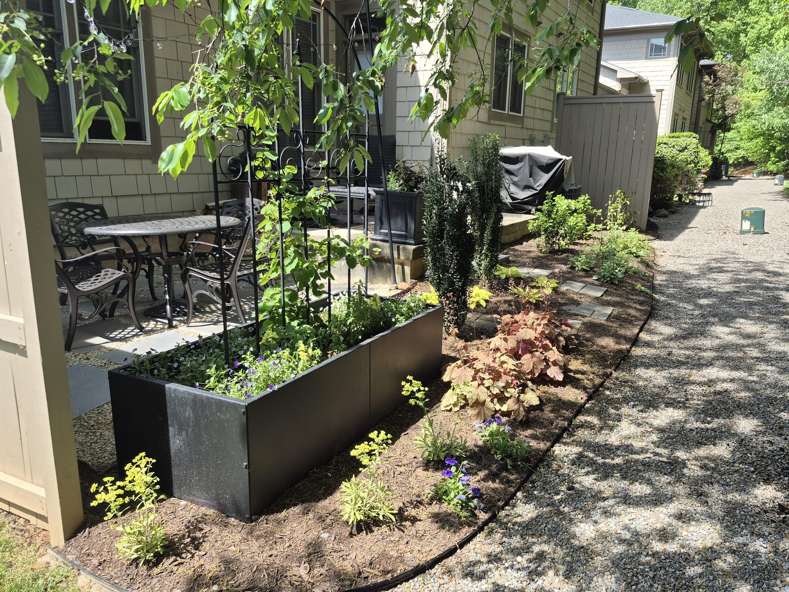 Raised planter lush with flowering annuals and greenery