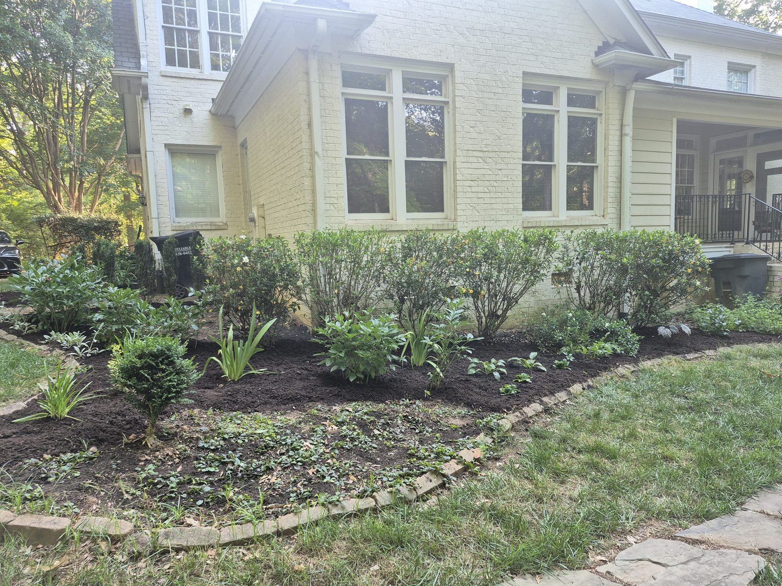 Completed foundation woodland garden with full mulched planting bed